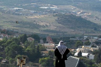 A Palestinian man looks towards the Israeli settlement of Shavei Shomron built next to the Palestinian village of Naqoura, west of Nablus in the occupied West Bank