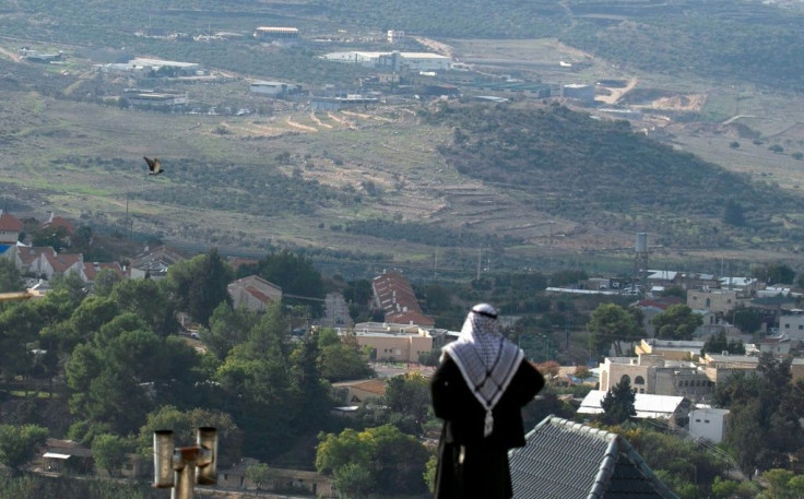 A Palestinian man looks towards the Israeli settlement of Shavei Shomron built next to the Palestinian village of Naqoura, west of Nablus in the occupied West Bank