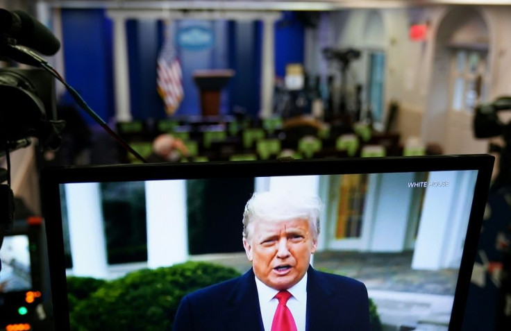Donald Trump is seen on TV from a video message released on Twitter on January 6 addressing rioters at the US Capitol