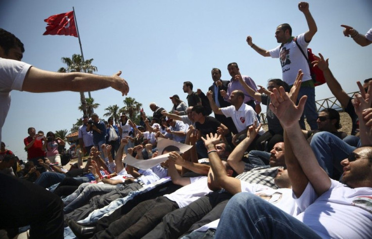 Supporters of Syria's President Bashar al-Assad shout slogans outside of a hotel where the opposition activists are gathered for a conference in Antalya