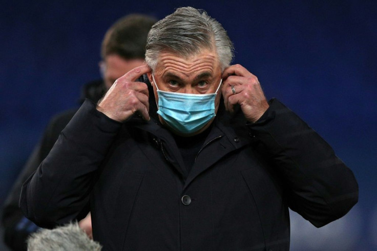 Everton coach Carlo Ancelotti adjusts his face mask after his side lost to West Ham on January 1