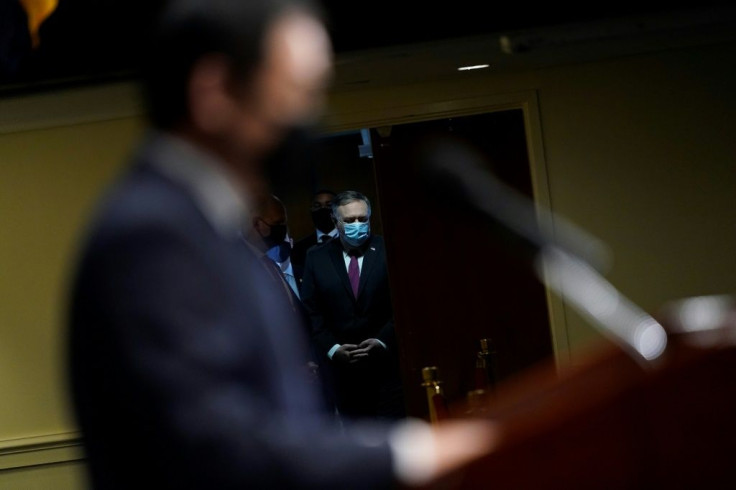 Secretary of State Mike Pompeo listens as he is introduced at a speech by Xiyue Wang, a US citizen who was imprisoned in Iran