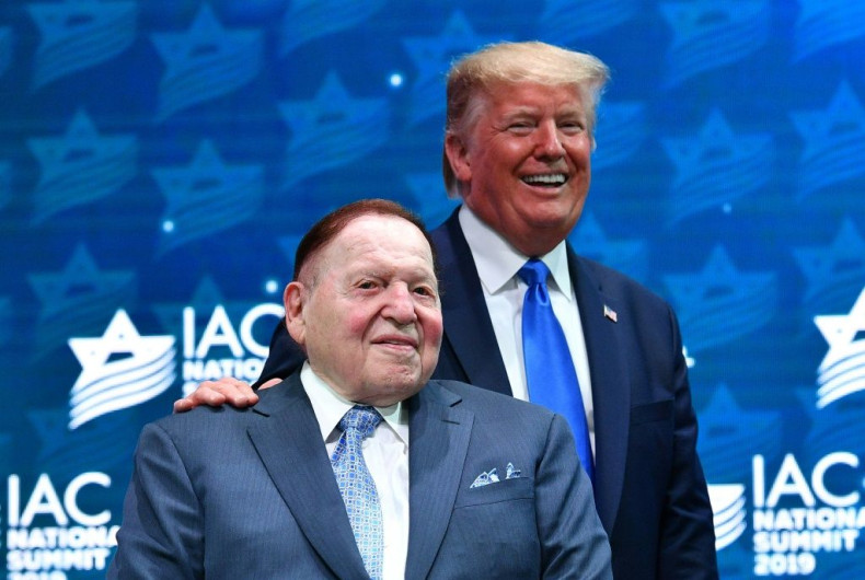 US President Donald Trump stands on stage with mogul Sheldon Adelson at a Florida event in 2019