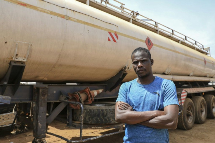 Stuck: Abderaman Hawara, 30, a truck driver from Chad, next to his rig