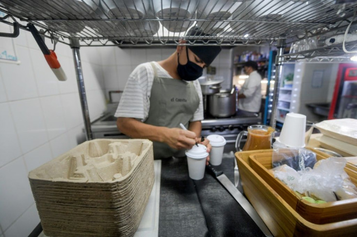 A restaurant worker prepares drinks using biodegradable packaging in Mexico City, which is banning many single-use plastics