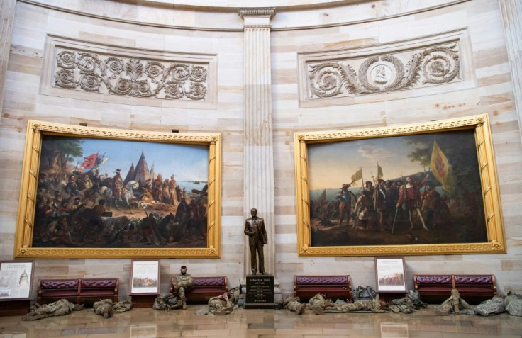 Members of the National Guard take a rest in the Rotunda of the US Capitol in Washington, DC, on January 13, 2021, ahead of the House vote impeaching US President Donald Trump