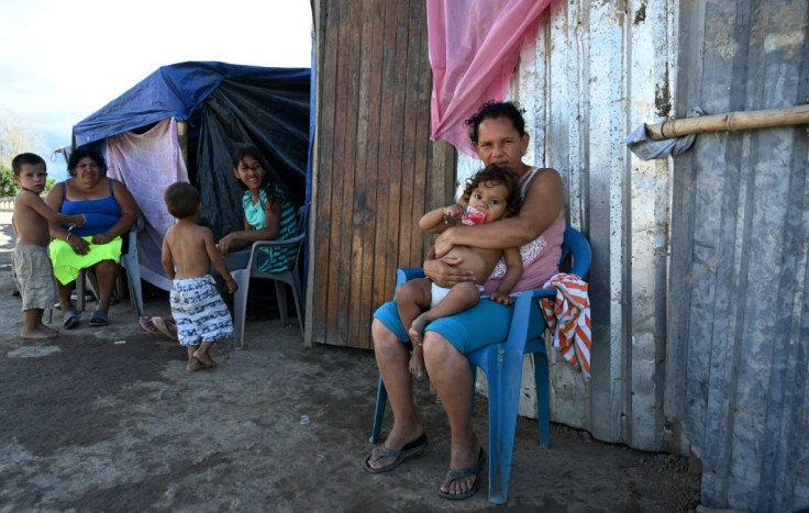 Many people in the impoverished Bon Samaritain neighborhood of La Lima dream of emigrating to the US