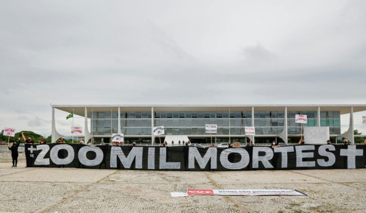 Demonstrators hold a banner reading "More than 200,000 Deaths" during a protest in honor of the two hundred thousand people killed by the coronavirus disease in Brazil, demanding a vaccine and against President Jair Bolsonaro January 8, 2021