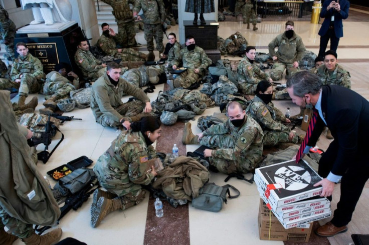 Members of the National Guard receive food in the Capitol Visitors Center on January 13, 2021 ahead of the House vote impeaching US President Donald Trump