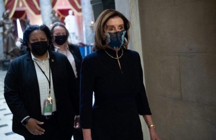 House Speaker Nancy Pelosi, who is known for her suits' bright colors, opted for the same dark outfit she wore for President Donald Trump's first impeachment