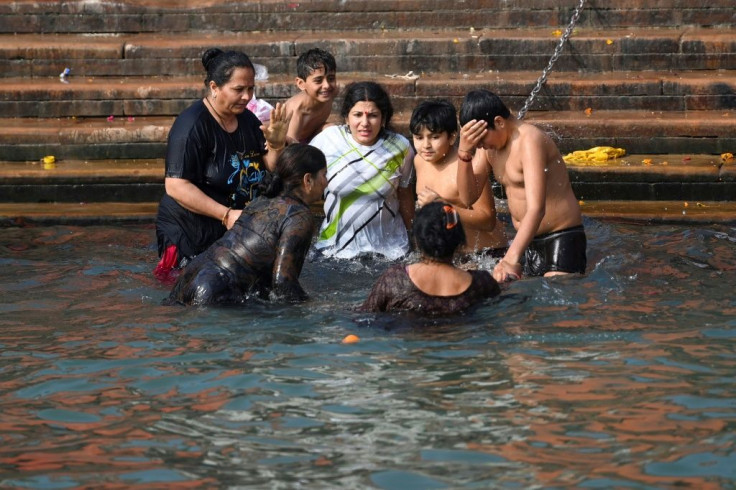 A Hindu family takes a dip at the start of Kumbh Mela