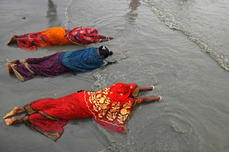 Hindu pilgrims offer prayers at the confluence of the Ganges and the Bay of Bengal