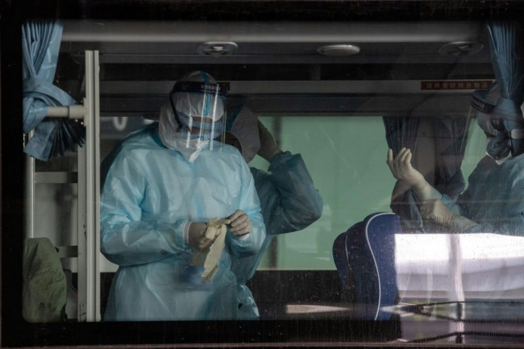 Health workers at Wuhan's international airport as a World Health Organization team arrives to investigate the origins of the Covid-19 pandemic