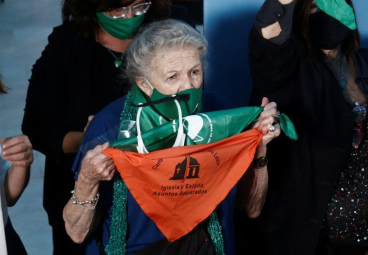 A woman celebrates after Argentina's President Alberto Fernandez approved the abortion law known as Voluntary Interruption of Pregnancy Law (IVE in Spanish), in Buenos Aires, on January 14, 2021