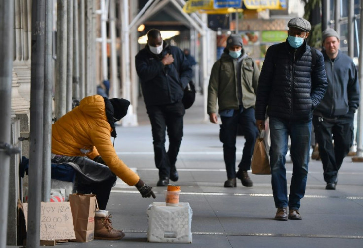 Americans, including this panhandler in New York, are suffering from an economic downturn brought on by the deadly coronavirus pandemic