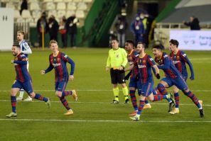 Barcelona celebrate their penalty shootout win over Real Sociedad in the semi-finals of the Spanish Super Cup