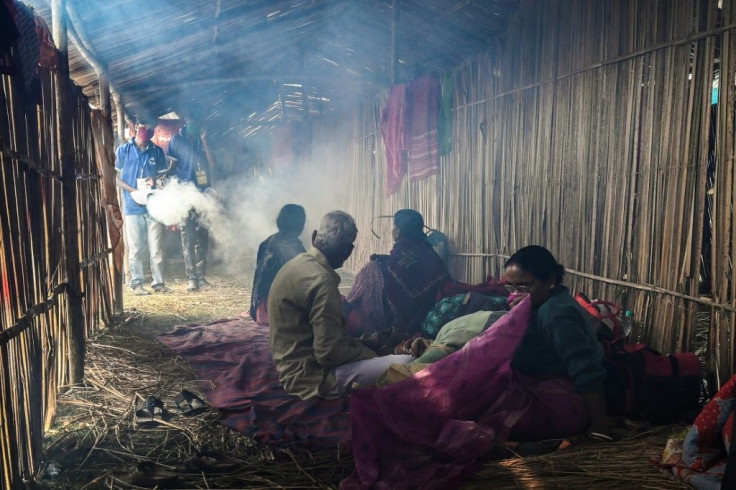Workers fumigate a temporary tent of pilgrims as a preventive measure against the Covid-19 coronavirus during the religious festival of Makar Sankranti on Sagar Island on January 13, 2021