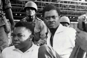 December 1960: Soldiers guard Congo's first post-independence prime minister, Patrice Lumumba, right, after his arrest. To the left is Joseph Okito, vice president of the Senate, who was shot dead alongside Lumumba the following month