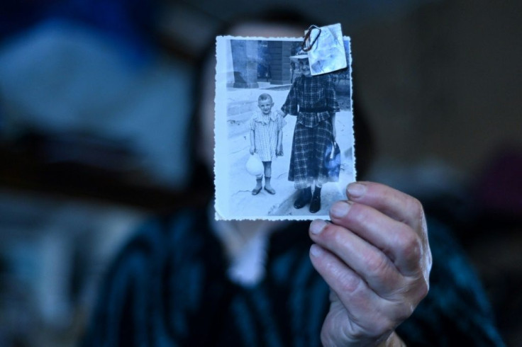 Yelizaveta Mikhaylova, with a photo of herself as a child, has been living in a village five hours' drive from Moscow