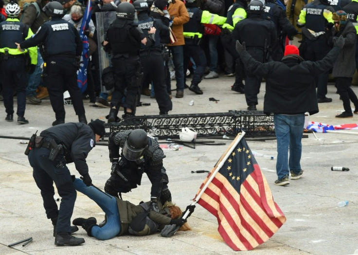 Police detain a person  during the attack by supporters of US President Donald Trump on the US Capitol