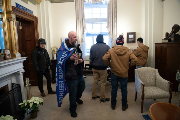 Supporters of US President Donald Trump walk through the office suite of Speaker of the House Nancy Pelosi after breaking through police lines and entering the US Capitol
