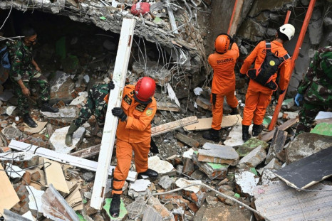 Rescuers searched for survivors at a collapsed building in Mamuju city