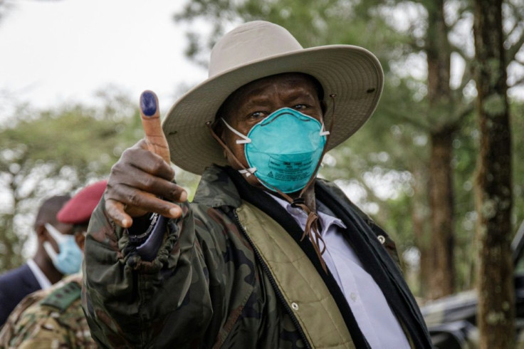 Ugandan President Yoweri Museveni shows his ink-marked thumb after casting his ballot at a polling station in Kiruhura, Uganda on Thursday.