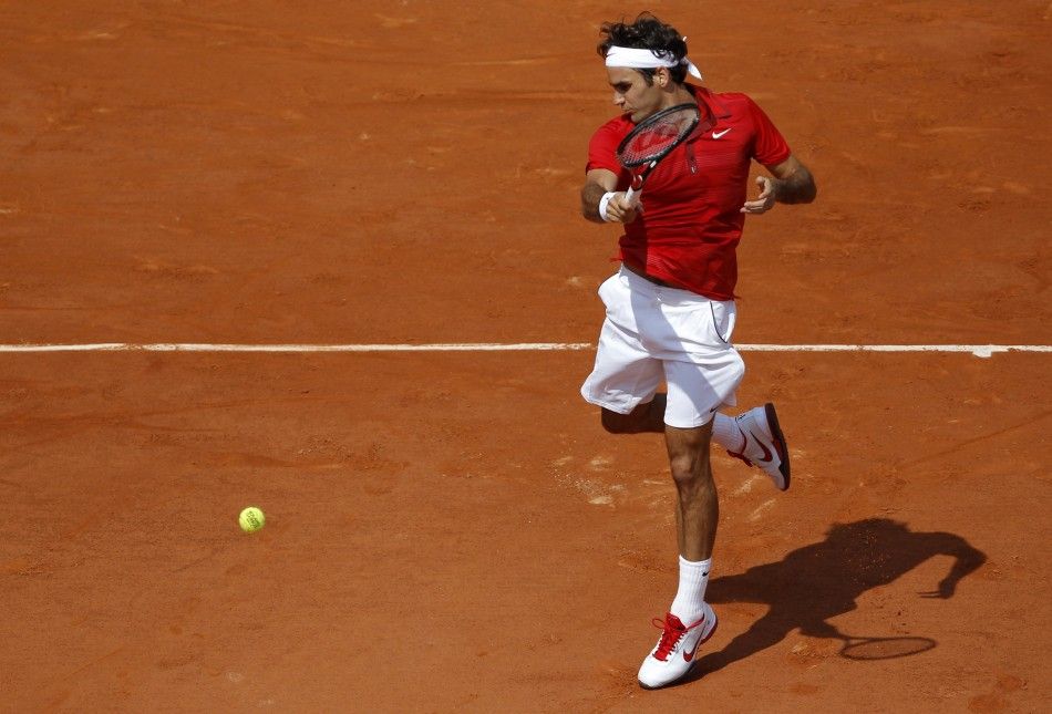 Federer of Switzerland returns the ball to Nadal of Spain