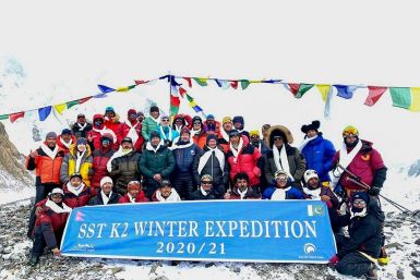 This handout photo taken on January 16, 2021 by Seven Summit Treks shows the historic team of 10 Nepali mountaineers and Sherpas after reaching the summit of K2, the second-highest mountain in the world, in the Gilgit-Baltistan region of Pakistan