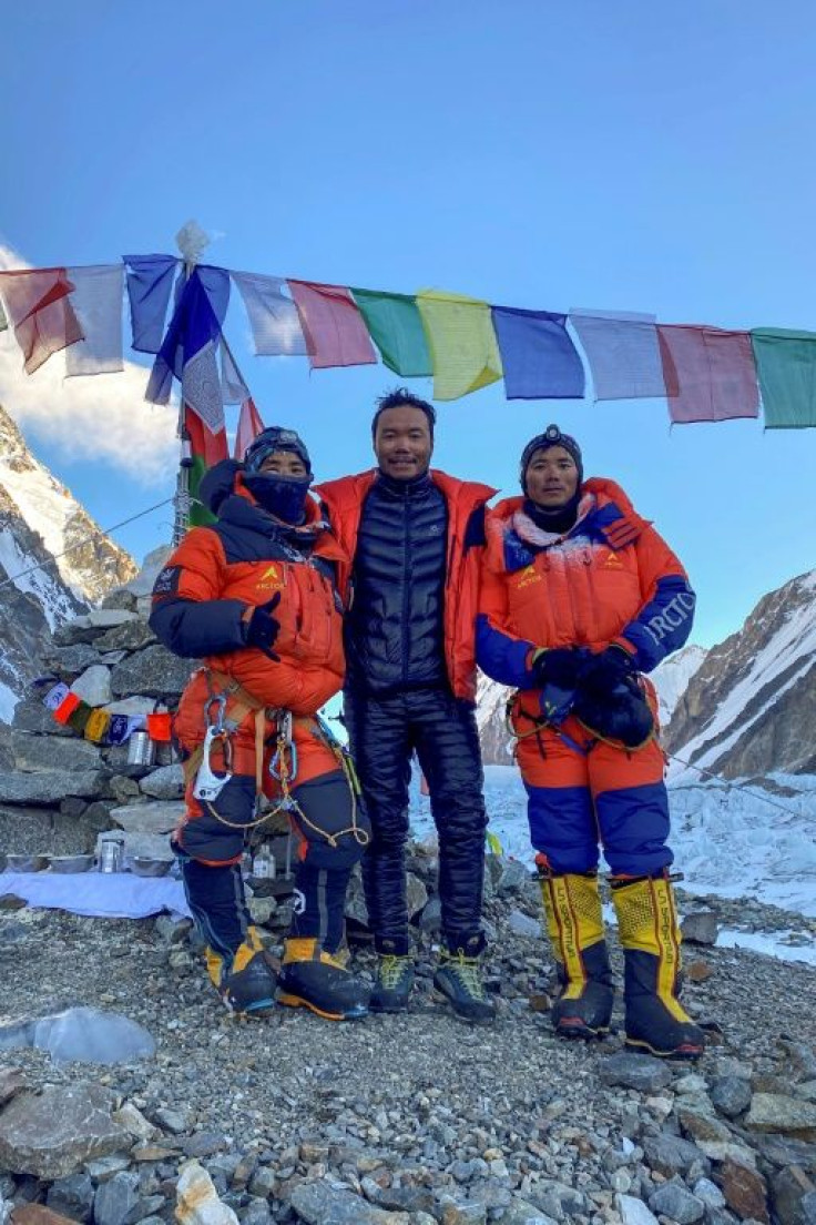 This photo taken on January 16, 2021 by Seven Summit Treks shows Nepali mountaineers Sona Sherpa (R), Galje Sherpa (L) and Chhang Dawa Sherpa after reaching the summit of K2, in the Gilgit-Baltistan region of Pakistan