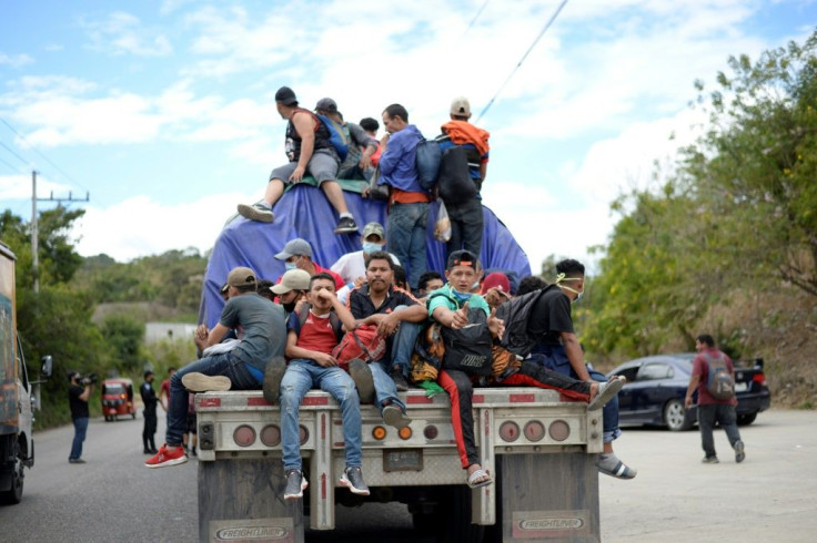Honduran migrants, part of a caravan seeking to reach the United States, get a ride on a truck in Camotan, Guatemala on January 16, 2021