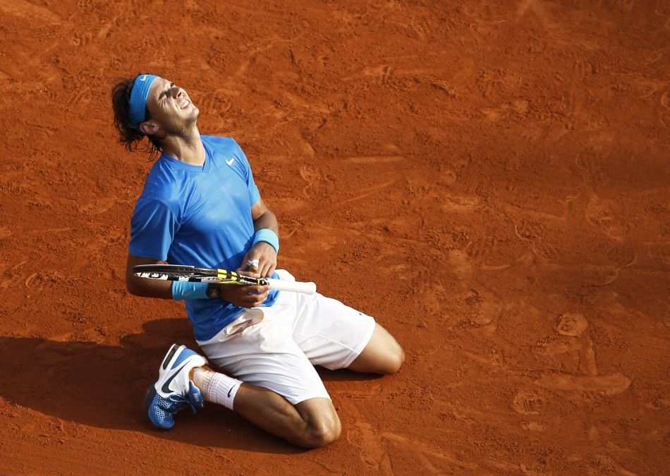 Nadal of Spain reacts after defeating Federer of Switzerland