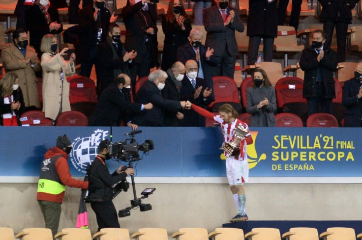Athletic Bilbao's Iker Muniain receives the winner's trophy at the Spanish Super Cup final