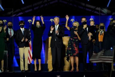 US President-elect Joe Biden (C) with his wife Jill Biden and members of their family  salute the crowd on stage after delivering remarks in Wilmington, Delaware, on November 7, 2020