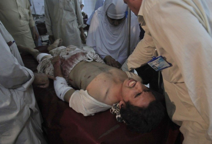 A nurse attends to a man who was injured by a bomb blast at hospital in Peshawar