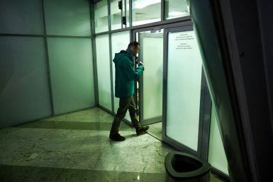 Russian opposition leader Alexei Navalny enters a room at the passport control point at Moscow's Sheremetyevo airport before he was taken away