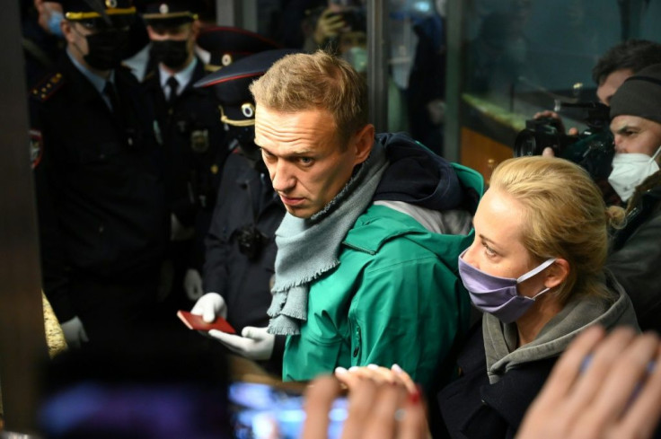 Russian opposition leader Alexei Navalny was carried away by police on arrival in Moscow, sparking a wave of Western condemnation