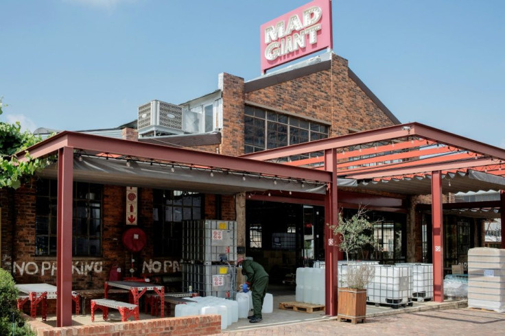 A worker fills a jerrycan of sanitiser at the Mad Giant Brewery, in Newtown, Johannesburg