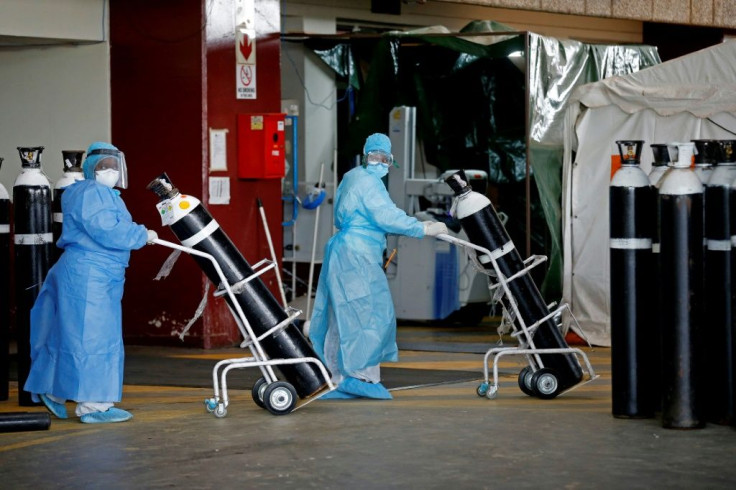 South Africa has been badly hit by coronavirus. At the Steve Biko Academic Hospital in Pretoria, health workers take oxygen tanks into a temporary ward for Covid patients
