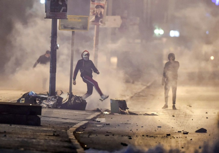 Protesters clash with security forces in a suburb on the northwestwern outskirts of Tunisia's capital on Sunday