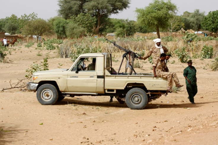 Conflict in Sudan's Darfur left the vast western region awash with weapons and divided by bitter rivalries; this 2006 photograph shows Sudanese security forces deploying during a rally