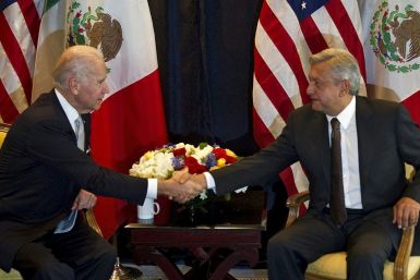 This file photo from March 5, 2012 shows then US Vice President Joe Biden (L) shaking hands with then candidate and now Mexican president Andres Manuel Lopez Obrador in Mexico City; the two countries have clashed over cooperation on drug matters