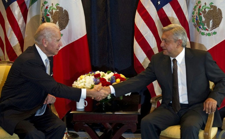 This file photo from March 5, 2012 shows then US Vice President Joe Biden (L) shaking hands with then candidate and now Mexican president Andres Manuel Lopez Obrador in Mexico City; the two countries have clashed over cooperation on drug matters