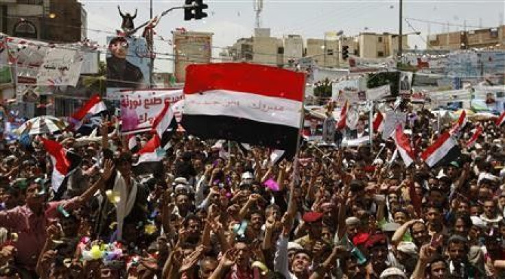 Anti-government protesters wave national flags as they celebrate Yemeni President Ali Abdullah Saleh&#039;s departure to Saudi Arabia in Sanaa June 5, 2011.