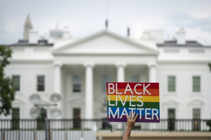 A protester holds up a 'Black Lives Matter' sign outside the White House