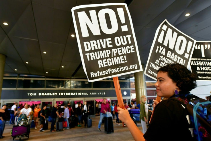 Activists shown at Los Angeles International Airport in 2017 protesting US President Donald Trump's ban temporarily barring entry into the US from Libya, Iran, Somalia, Sudan, Syria and Yemen