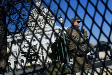 US National Guard soldiers patrol the Capitol on January 14, 2020 as part of massive security measures ahead of President-elect Joe Biden's inauguration following mob violence by outgoing president Donald Trump's supporters