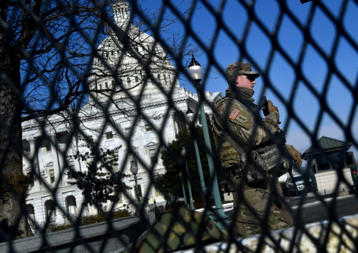US National Guard soldiers patrol the Capitol on January 14, 2020 as part of massive security measures ahead of President-elect Joe Biden's inauguration following mob violence by outgoing president Donald Trump's supporters