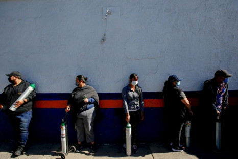 People queue to refill oxygen tanks for their relatives infected with COVID-19, due to shortages in medicinal gas following an increase in coronavirus cases, in Guadalajara, Jalisco State, Mexico on January 17, 2021.