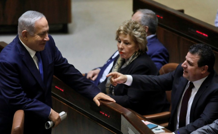 Israeli Prime Minister Benjamin Netanyahu (L) speaks at the Knesset in 2018 with Ayman Odeh, the head of the mainly Arab Joint List alliance, which won an unprecedented 15 seats in Israel's last election